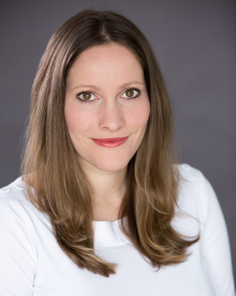 Image of Laura Bates. She has long brown hair, is wearing a white top, and is a white woman.