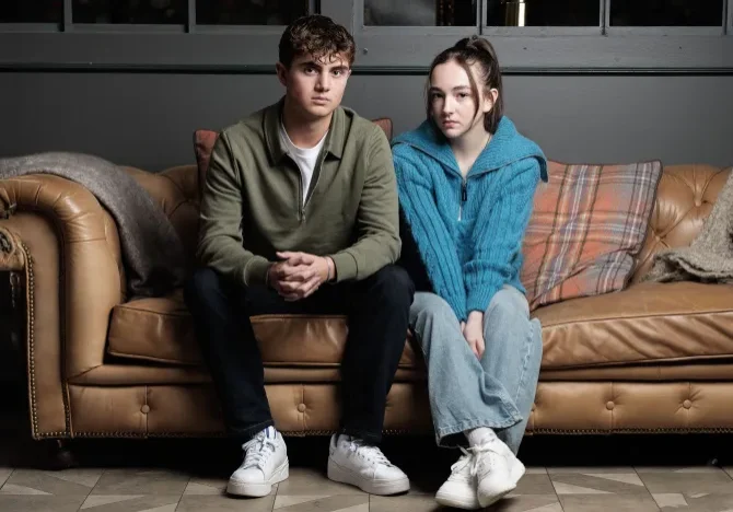Hollyoaks-JJ-and-Frankie-@Limepictures one young male and one young female sitting next to each other on the couch